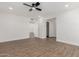 Bright bedroom with wood-look floors and ceiling fan at 10922 W Granada Dr, Sun City, AZ 85373