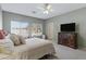 King-size bed, dresser, and window in this bright bedroom at 1102 E Bartlett Way, Chandler, AZ 85249