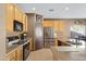 Bright kitchen featuring wood cabinets and stainless steel appliances at 1102 E Bartlett Way, Chandler, AZ 85249
