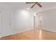 Bright bedroom with wood flooring, ceiling fan and access to hallway at 11030 W Pleasant Valley W Rd, Sun City, AZ 85351