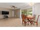 Bright dining area with wood table and chairs, view to backyard at 11030 W Pleasant Valley W Rd, Sun City, AZ 85351