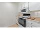 Kitchen features electric stovetop, microwave, and ample cabinetry at 11030 W Pleasant Valley W Rd, Sun City, AZ 85351