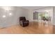 Living room with hardwood floors, recliner, and view of dining area at 11030 W Pleasant Valley W Rd, Sun City, AZ 85351
