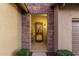 Inviting entryway with stone accents and a security door at 11105 E Quintana Ave, Mesa, AZ 85212