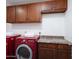 Bright laundry room, features washer, dryer, and ample cabinet space at 1134 W Dunbar Dr, Tempe, AZ 85282