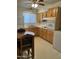 Simple kitchen with light wood cabinets and a small dining area at 12439 N Augusta Dr, Sun City, AZ 85351