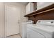 Convenient laundry room with washer, dryer, and storage at 1350 W Seascape Dr, Gilbert, AZ 85233