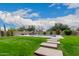 Backyard with a pool, lawn, and patio furniture at 14918 W Escondido Dr, Litchfield Park, AZ 85340