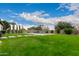 Backyard with a pool and lush green lawn at 14918 W Escondido Dr, Litchfield Park, AZ 85340