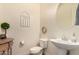 Clean and bright bathroom with pedestal sink and updated fixtures at 14918 W Escondido Dr, Litchfield Park, AZ 85340