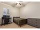 Bright bedroom with a double bed, desk, and dresser at 14918 W Escondido Dr, Litchfield Park, AZ 85340