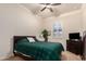 Guest bedroom with plaid bedding and ceiling fan at 14918 W Escondido Dr, Litchfield Park, AZ 85340