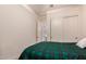 Bright bedroom with plaid bedding and double door closet at 14918 W Escondido Dr, Litchfield Park, AZ 85340