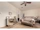 Main bedroom with tufted headboard and sitting area at 14918 W Escondido Dr, Litchfield Park, AZ 85340