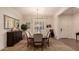 Elegant dining room with chandelier and seating for six at 14918 W Escondido Dr, Litchfield Park, AZ 85340