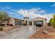 Two-story house with a three-car garage and nicely landscaped yard at 14918 W Escondido Dr, Litchfield Park, AZ 85340