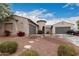 Two-story house with three-car garage and landscaped front yard at 14918 W Escondido Dr, Litchfield Park, AZ 85340
