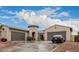 Two-story house with a three-car garage and nicely landscaped yard at 14918 W Escondido Dr, Litchfield Park, AZ 85340