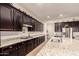 Spacious kitchen with granite countertops and dark wood cabinets at 14918 W Escondido Dr, Litchfield Park, AZ 85340