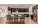 Modern kitchen with granite countertops and dark cabinets at 14918 W Escondido Dr, Litchfield Park, AZ 85340