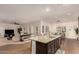 Open concept kitchen and living area with island and breakfast bar at 14918 W Escondido Dr, Litchfield Park, AZ 85340