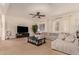 Spacious living room featuring comfortable seating and a large TV at 14918 W Escondido Dr, Litchfield Park, AZ 85340