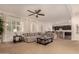 Spacious living room with large sectional sofa and view into kitchen at 14918 W Escondido Dr, Litchfield Park, AZ 85340