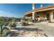 Inviting backyard patio featuring a covered terrace, stone accents, lush landscaping, and sparkling pool at 15402 E Crested Butte Trl, Fountain Hills, AZ 85268