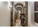 Elegant stone hallway with arched entryways and ornate details at 15402 E Crested Butte Trl, Fountain Hills, AZ 85268