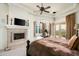 Main bedroom with a fireplace, a treadmill, and access to a private patio at 15402 E Crested Butte Trl, Fountain Hills, AZ 85268
