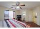 Bright bedroom with king bed, en-suite bathroom access, and ceiling fan at 1643 E Bishop Dr, Casa Grande, AZ 85122