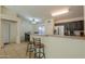 Kitchen with dark wood cabinets, stainless steel appliances, and a breakfast bar at 1643 E Bishop Dr, Casa Grande, AZ 85122