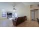 Living room with a brown sofa, large TV, and French doors leading to a patio at 1643 E Bishop Dr, Casa Grande, AZ 85122