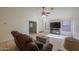 Spacious living room featuring a large TV, comfortable seating, and tile flooring at 1643 E Bishop Dr, Casa Grande, AZ 85122