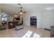 Living room with a brown leather sofa, tile floor, and access to other rooms at 1643 E Bishop Dr, Casa Grande, AZ 85122