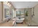 Spa-like bathroom with a soaking tub, walk-in shower, and updated fixtures at 1656 E Montoya Ln, Phoenix, AZ 85024