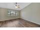 Bright bedroom with hardwood floors, window, and ceiling fan at 1656 E Montoya Ln, Phoenix, AZ 85024
