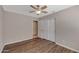 Spacious bedroom with hardwood floors, ceiling fan, and double doors to closet at 1656 E Montoya Ln, Phoenix, AZ 85024
