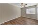 Well-lit bedroom featuring wood-look floors and window blinds at 1656 E Montoya Ln, Phoenix, AZ 85024