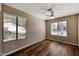 Room with wood-look floors and two large windows at 1656 E Montoya Ln, Phoenix, AZ 85024