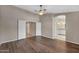 Large bedroom with hardwood floors, ceiling fan, and access to bathroom at 1656 E Montoya Ln, Phoenix, AZ 85024