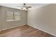 Well-lit bedroom with hardwood floors and a ceiling fan at 1656 E Montoya Ln, Phoenix, AZ 85024