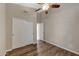 Bright bedroom with wood-look floors and double door closet at 1656 E Montoya Ln, Phoenix, AZ 85024