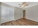 Spacious bedroom with wood-look floors and mirrored closet doors at 1656 E Montoya Ln, Phoenix, AZ 85024