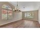 Bright dining room features hardwood floors, large windows, and a modern chandelier at 1656 E Montoya Ln, Phoenix, AZ 85024