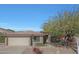 Single-story home with a two-car garage and mature landscaping at 1656 E Montoya Ln, Phoenix, AZ 85024