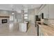 Open concept kitchen with island and white cabinets at 1656 E Montoya Ln, Phoenix, AZ 85024