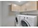 Laundry room with washer, dryer, and ample cabinets at 1656 E Montoya Ln, Phoenix, AZ 85024