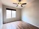 Spacious bedroom with wood floors and ceiling fan at 1704 E Redfield Rd, Gilbert, AZ 85234