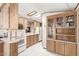 Kitchen boasts ample wood cabinetry and skylights at 17200 W Bell Rd # 439, Surprise, AZ 85374